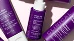 An array of Paula’s Choice clinical skincare products in purple bottles with white lids.