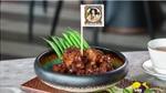 Sticky plant-based meat on a plate with The Vegetarian Butcher flag on it
