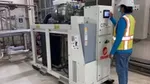 A factory worker programmes a heat pump in our Personal Care factory in Dubai.