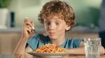 A boy tucks into a plate of food