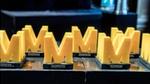 Rows of yellow, M-shaped awards. Photo by Bart van der Putten
