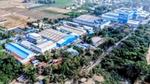 An aerial view of Unilever’s Home Care factory in Pondicherry, India, a network of large industrial buildings painted blue and white.