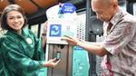 Man and woman refill bottle. Indonesian brand, Bango is one of 11 products on offer at Unilever’s pilot refillery.